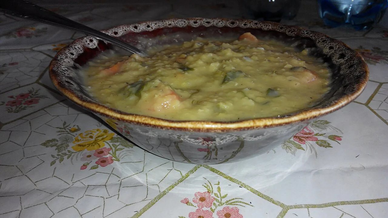 A bowl of thick red lentil soup ready for the table