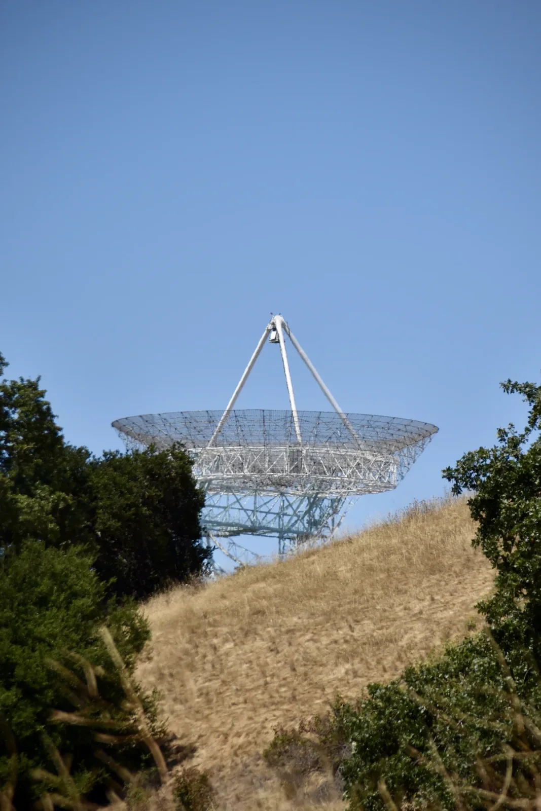 Large radio telescope dish on a hillside